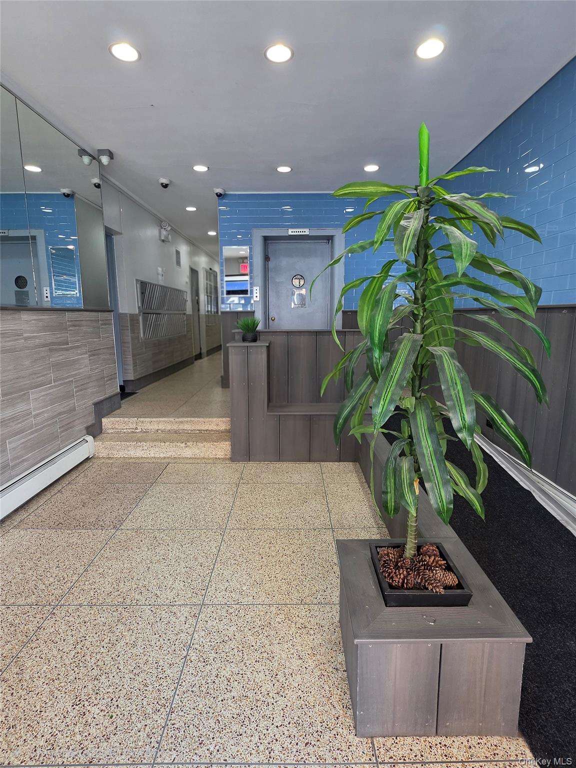 129 Beach 118th Street, Unit 5A Queens, NY 11694 - Photo 12 of 17 a lobby with furniture and a potted plant