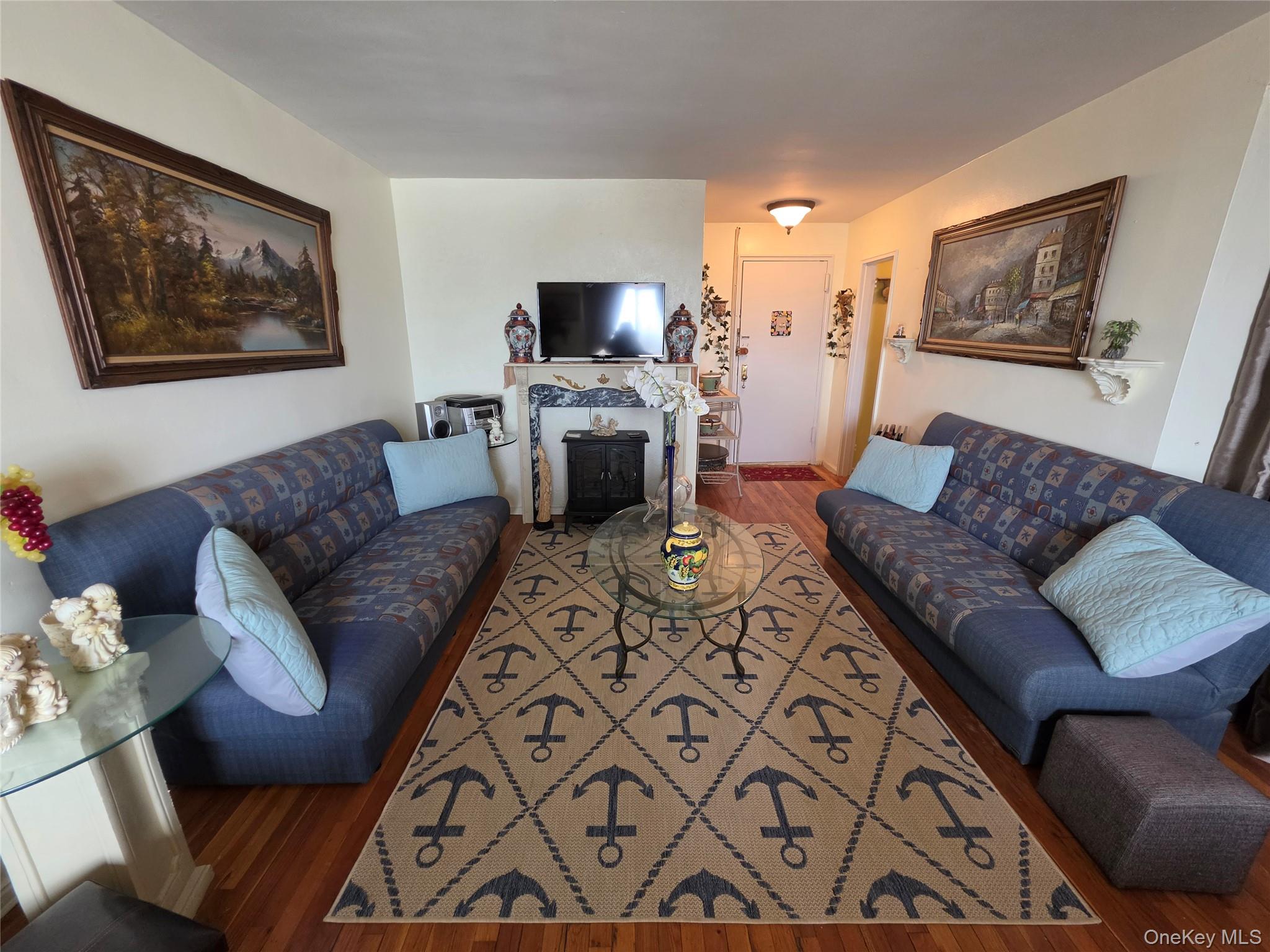 129 Beach 118th Street, Unit 5A Queens, NY 11694 - Photo 3 of 17 a living room with furniture and a flat screen tv