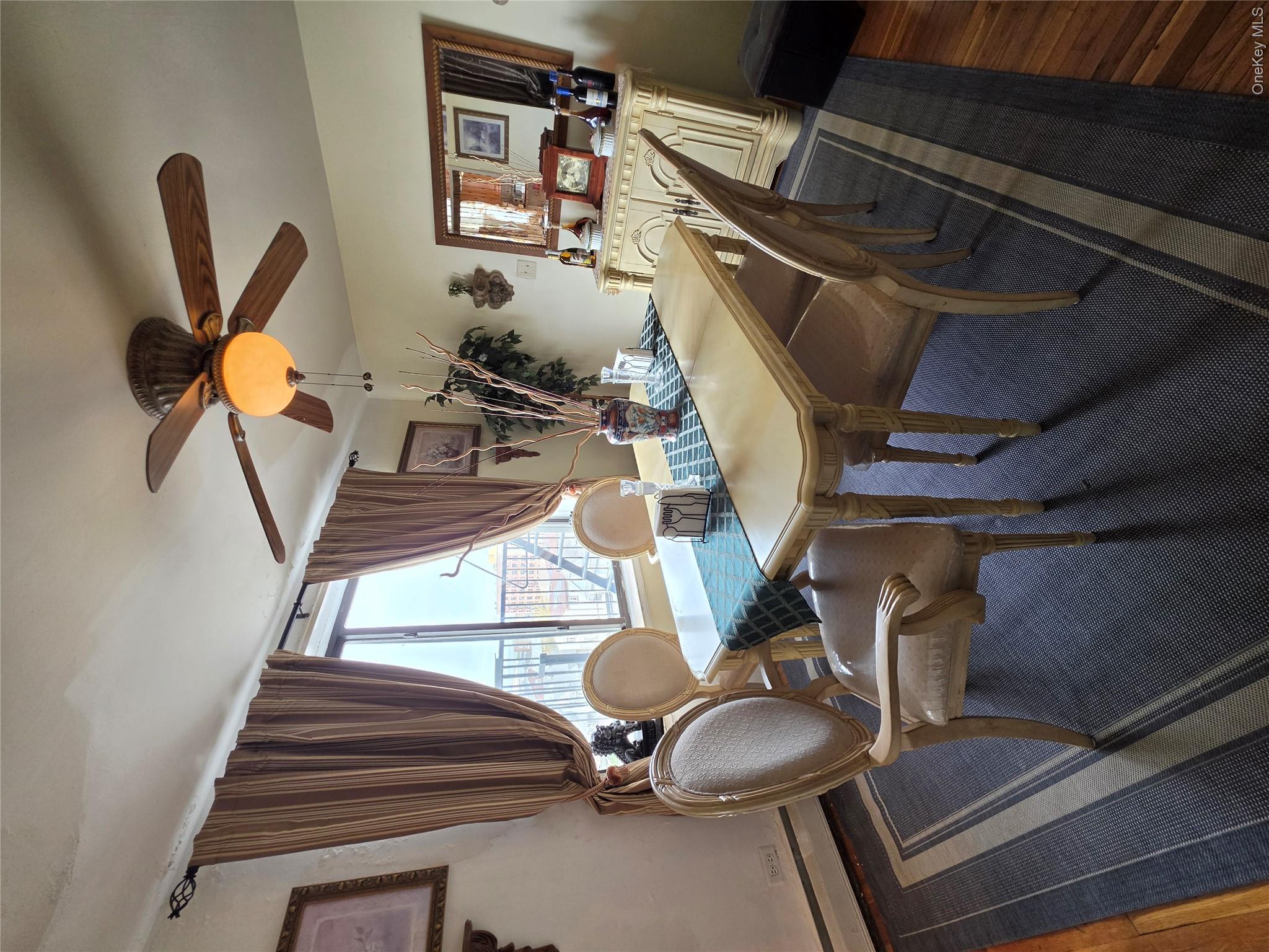 129 Beach 118th Street, Unit 5A Queens, NY 11694 - Photo 6 of 17 a view of a dining room with furniture window and wooden floor