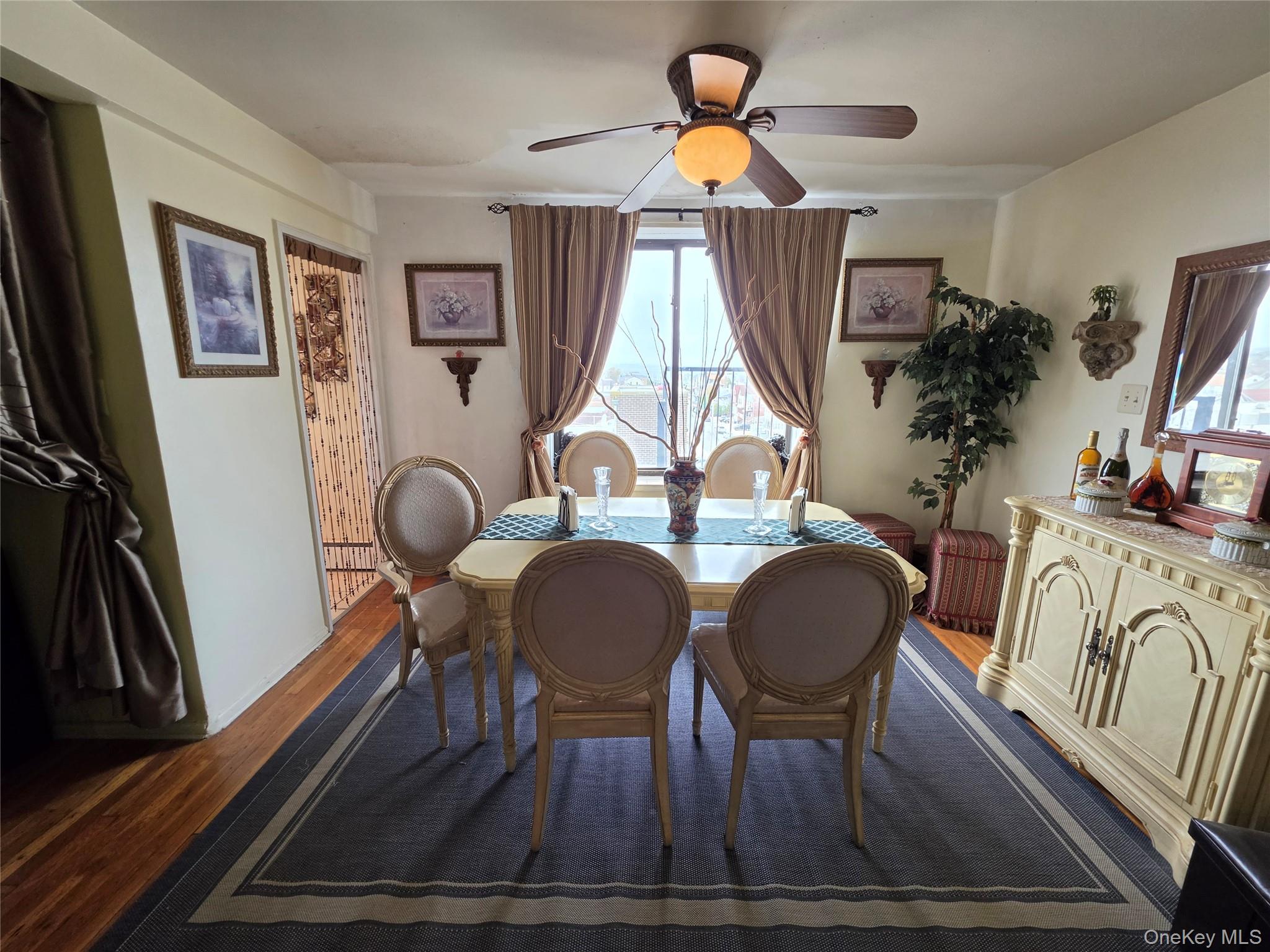 129 Beach 118th Street, Unit 5A Queens, NY 11694 - Photo 9 of 17 a view of a dining room with furniture and wooden floor