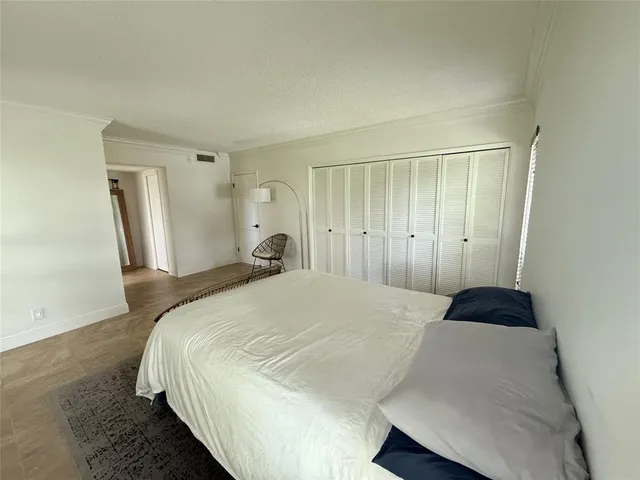 a bedroom with a bed and a walk in closet