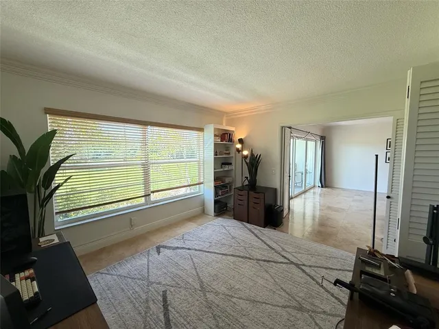 a bed room with a bed and a large window