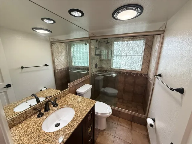 a bathroom with a sink a toilet a mirror and a tub