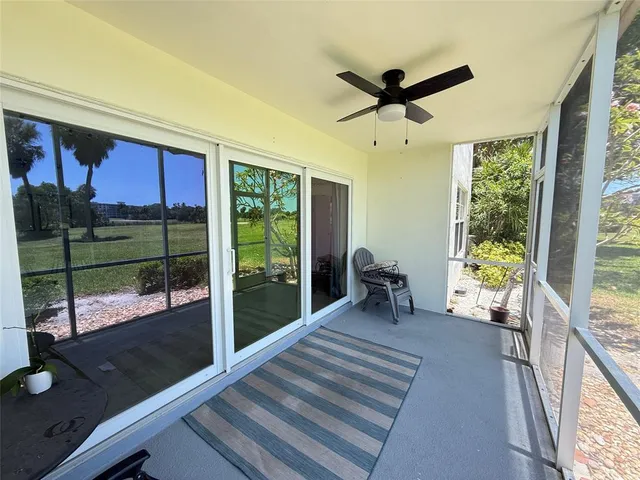a living room with hardwood floor and a ceiling fan