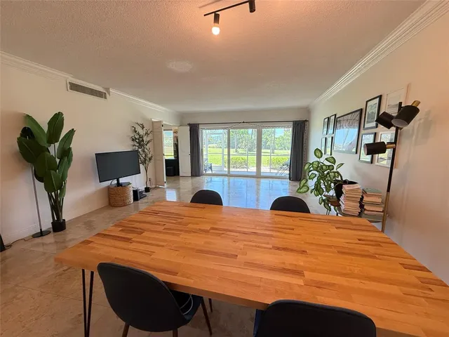 a bedroom with a bed a large window and potted plant