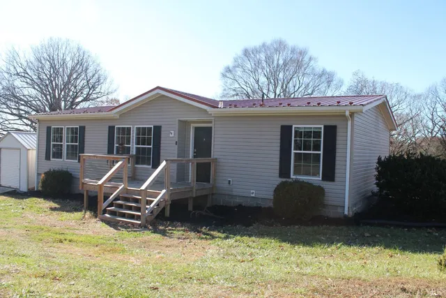 a view of a house with a yard chairs and couches chair