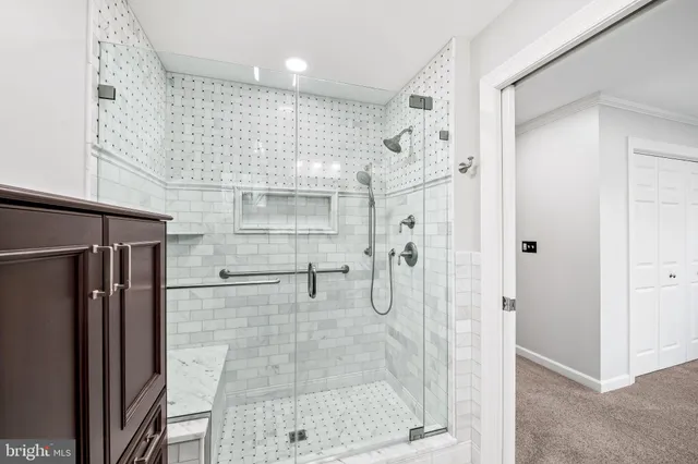 a bathroom with a shower and a glass door