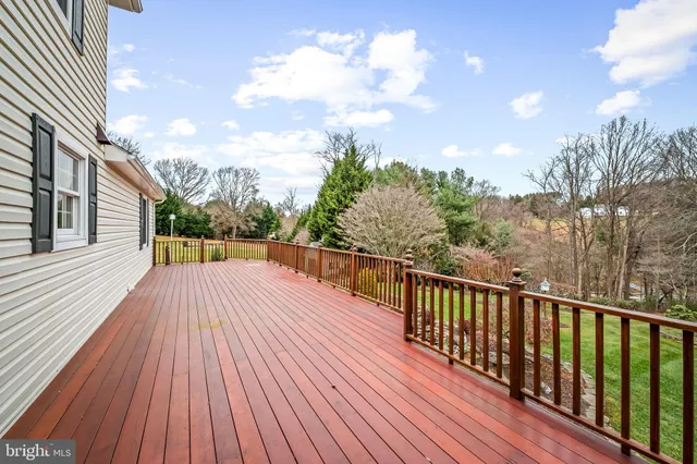 a balcony with wooden floor and fence