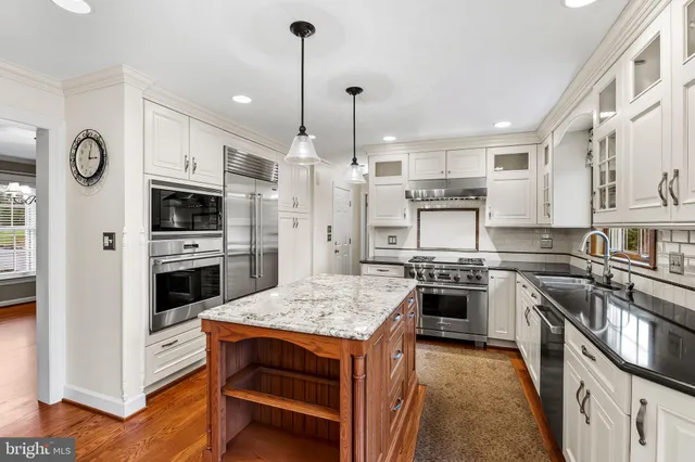 a kitchen with a stove a sink and a refrigerator