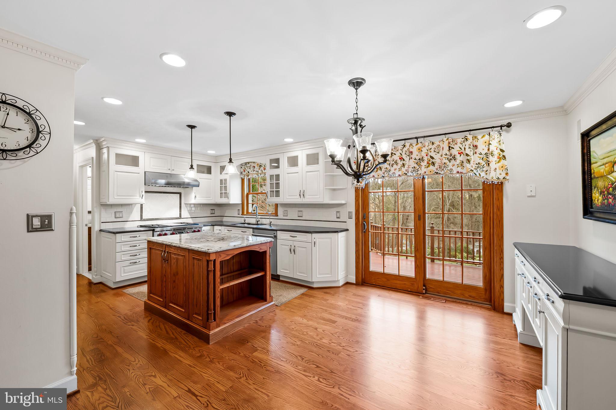 2202 Aquilas Delight Fallston, MD 21047 - Photo 8 of 35 a kitchen with stainless steel appliances granite countertop a stove a sink dishwasher a refrigerator and cabinets with wooden floor