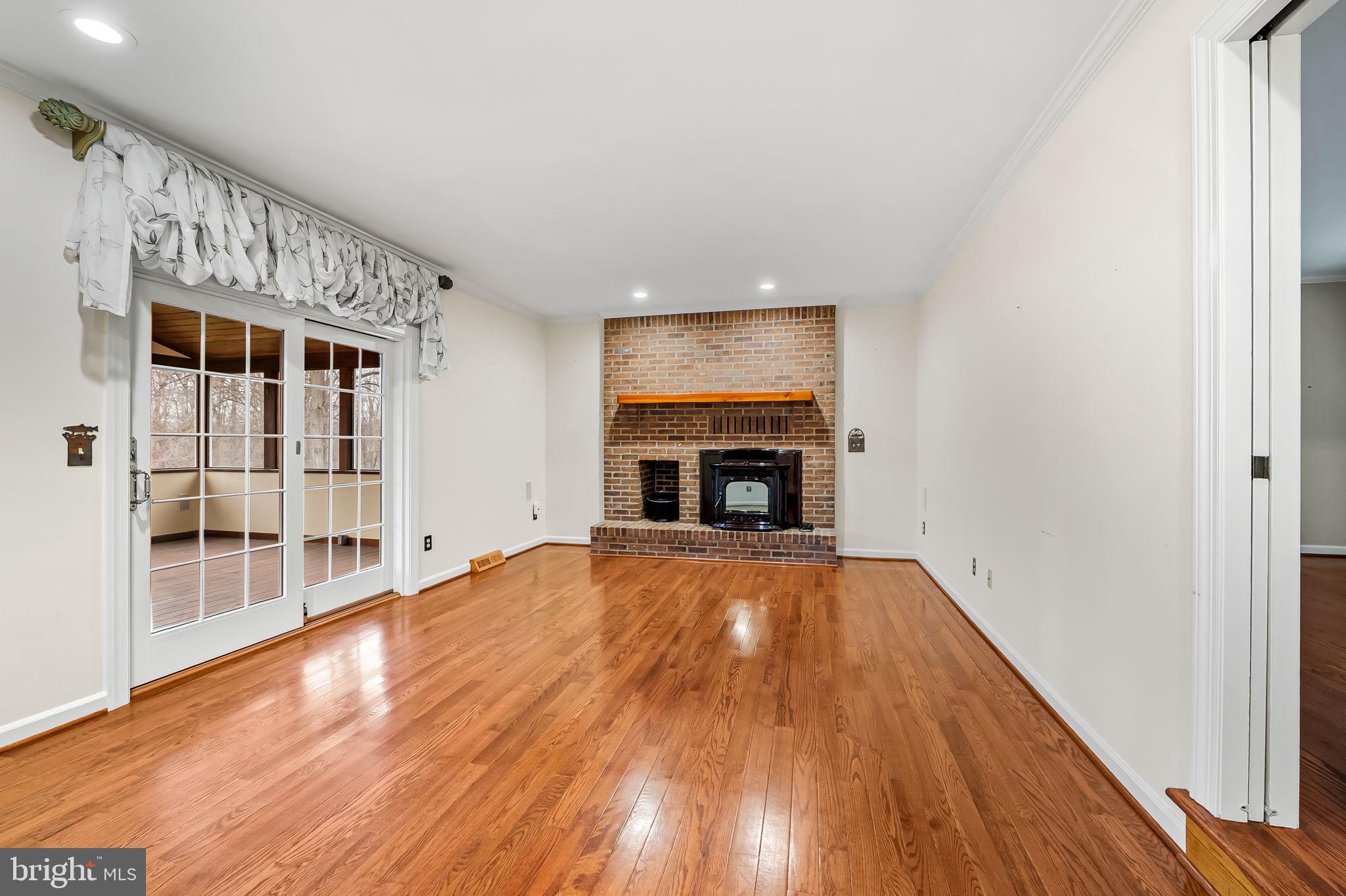 2202 Aquilas Delight Fallston, MD 21047 - Photo 9 of 35 a view of empty room with wooden floor and fireplace