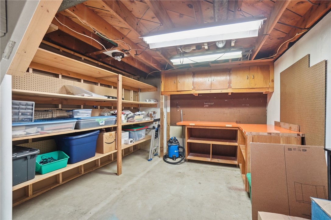 1325 Chelsea Road Troy, OH 45373 - Photo 35 of 42 This garage offers ample storage solutions with built-in shelving and a practical workbench.