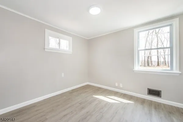 an empty room with wooden floor