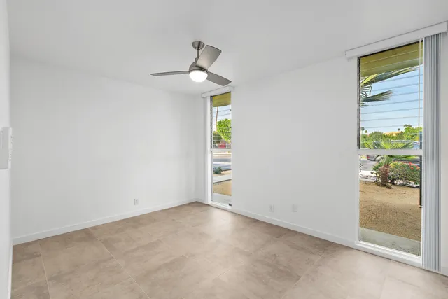 an empty room with windows and closet