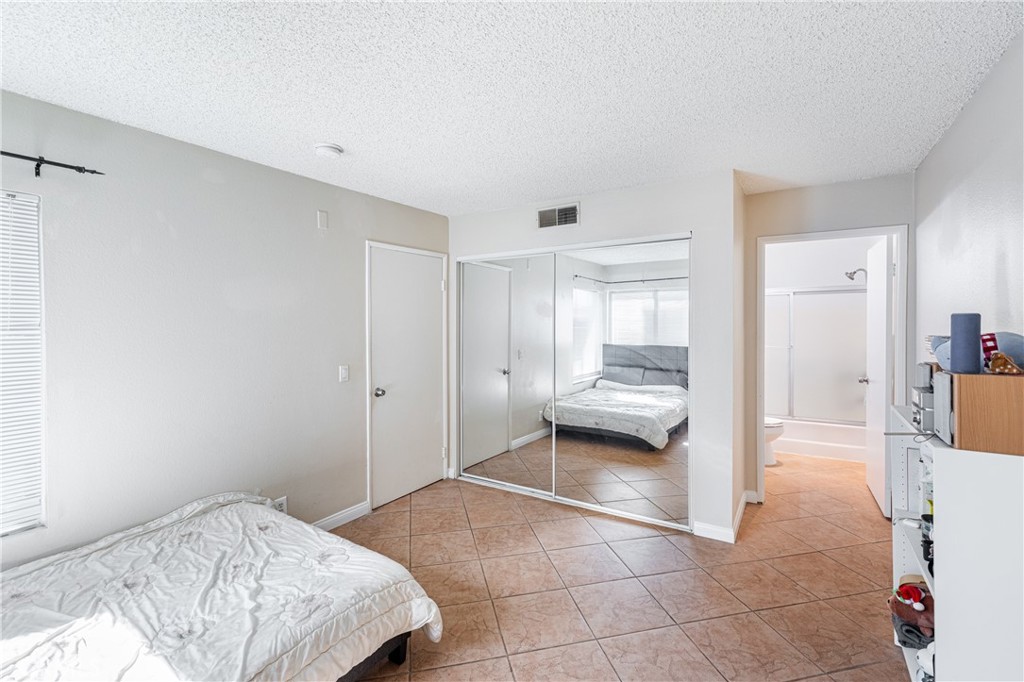 14610 Erwin Street, Unit 212 Van Nuys, CA 91411 - Photo 12 of 16 a bedroom with a bed and a view of bedroom