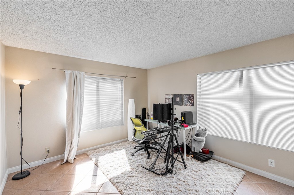 14610 Erwin Street, Unit 212 Van Nuys, CA 91411 - Photo 8 of 16 a view of a livingroom with lounge chair and a window