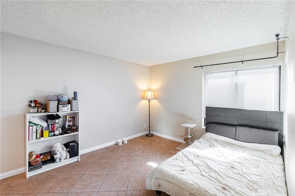 14610 Erwin Street, Unit 212 Van Nuys, CA 91411 - Photo 10 of 16 a bedroom with a bed and a window