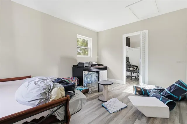 a bedroom with furniture and a wooden floor