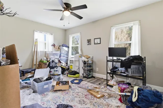 a living room with furniture a flat screen tv and a window