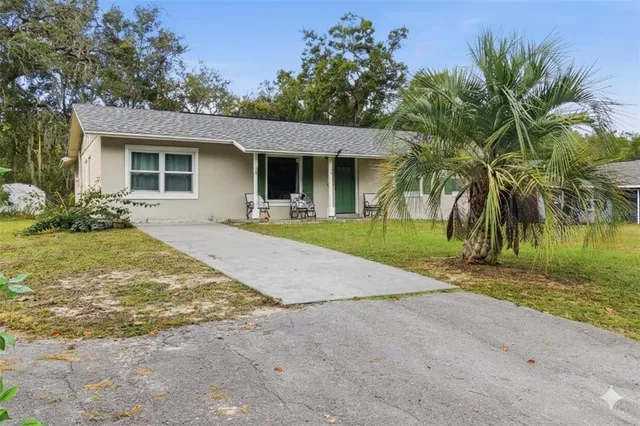 a front view of house with yard and trees