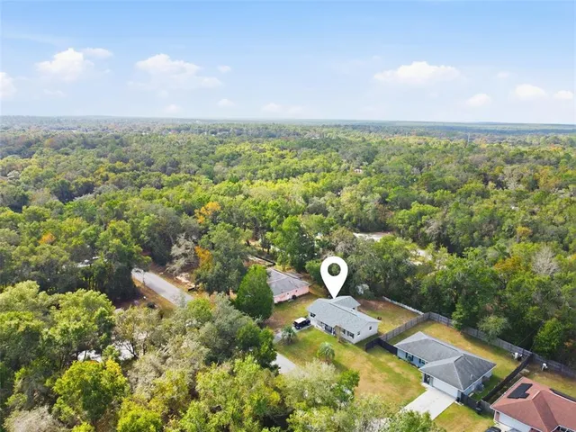 an aerial view of residential house with outdoor space and swimming pool