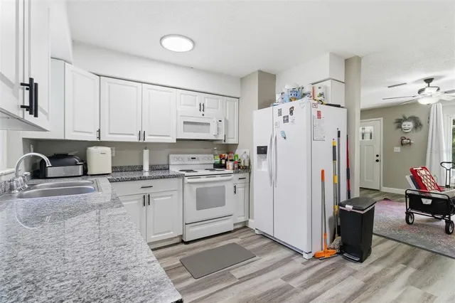 a kitchen with a refrigerator and a stove top oven