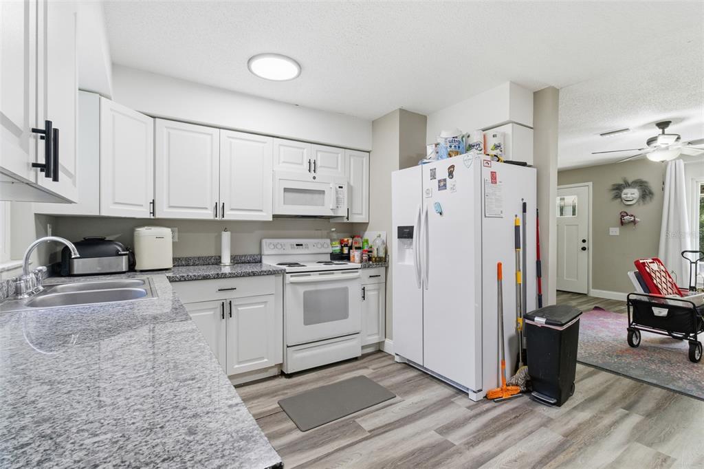 150 South Rooks Avenue Inverness, FL 34453 - Photo 5 of 30 a kitchen with a refrigerator and a stove top oven