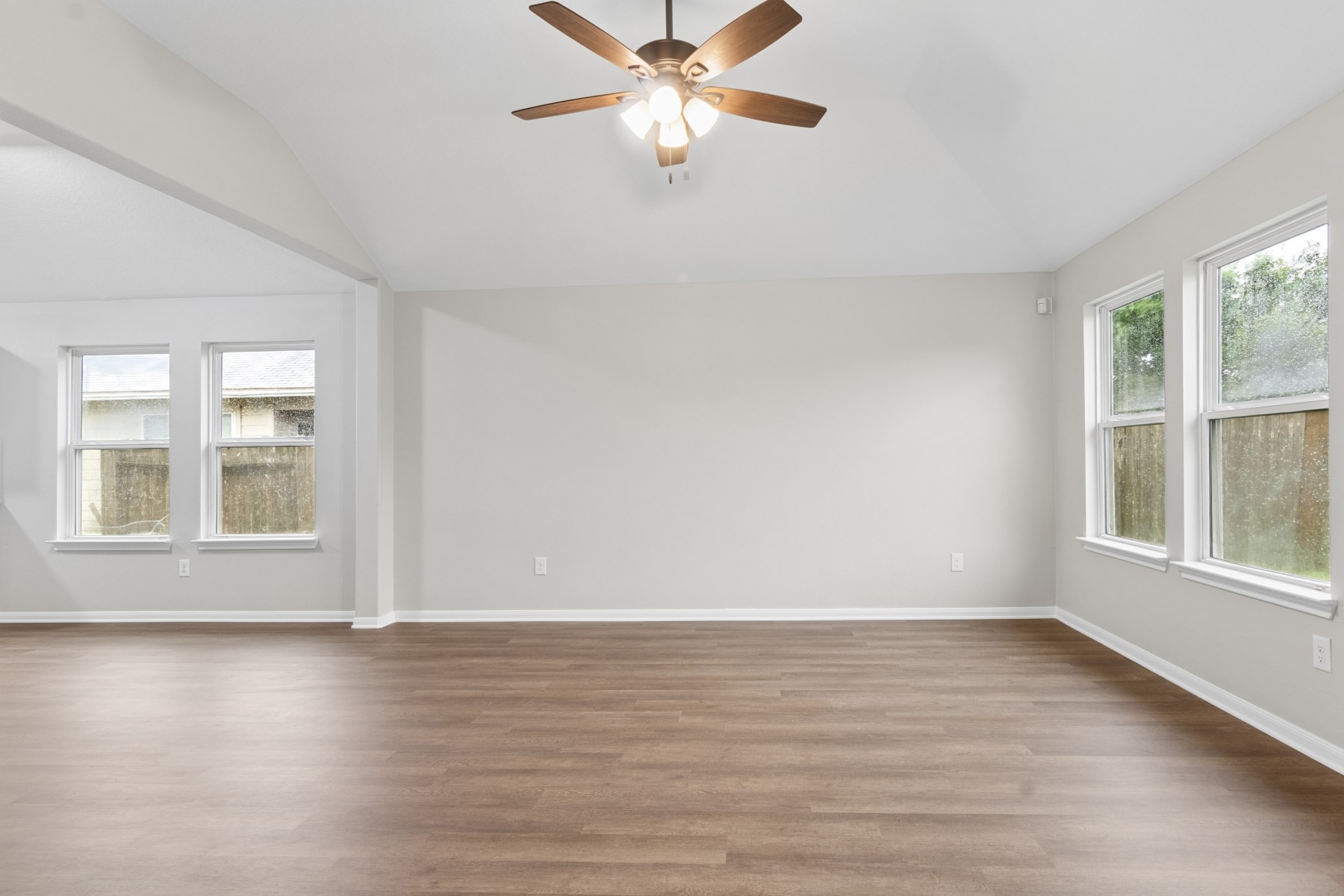 7811 Adonis Avenue Baytown, TX 77521 - Photo 8 of 36 wooden floor in an empty room with a window