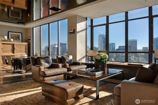 a living room with furniture and floor to ceiling windows