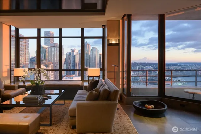 a living room with furniture and a floor to ceiling window
