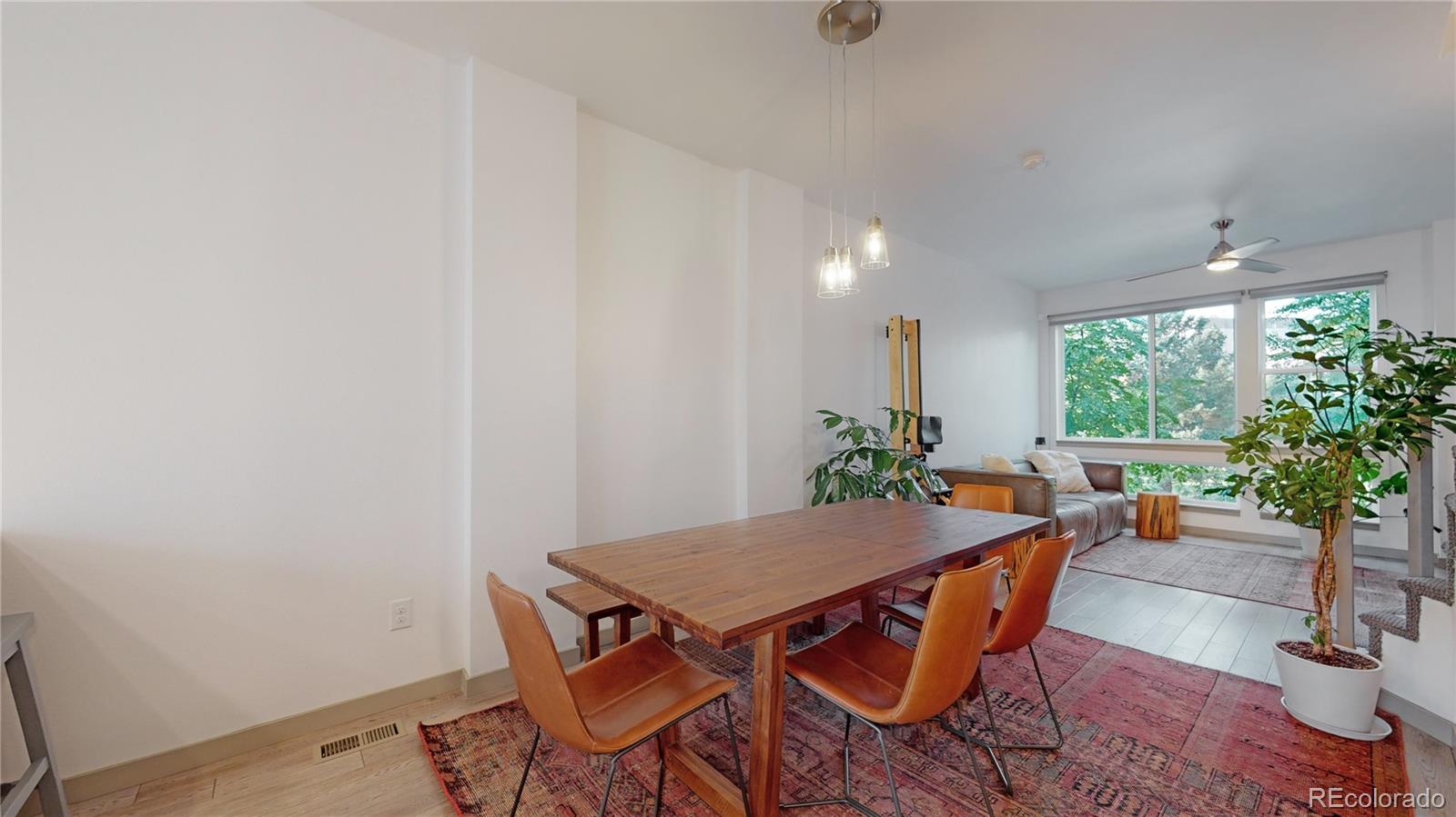 385 22nd Street, Unit 4 Denver, CO 80205 - Photo 11 of 40 a view of a dining room with furniture window and wooden floor