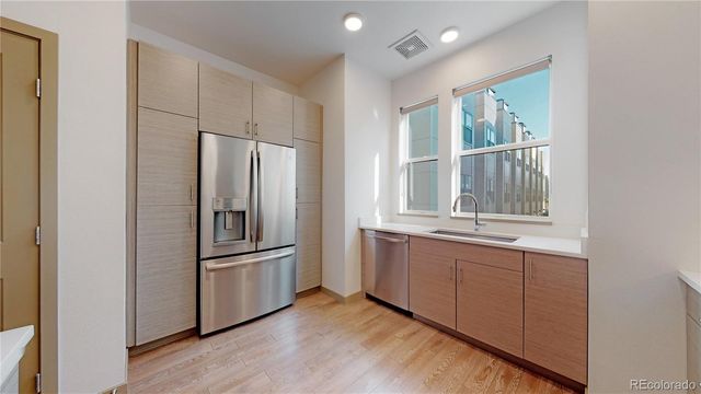 a kitchen with stainless steel appliances granite countertop a refrigerator and a sink