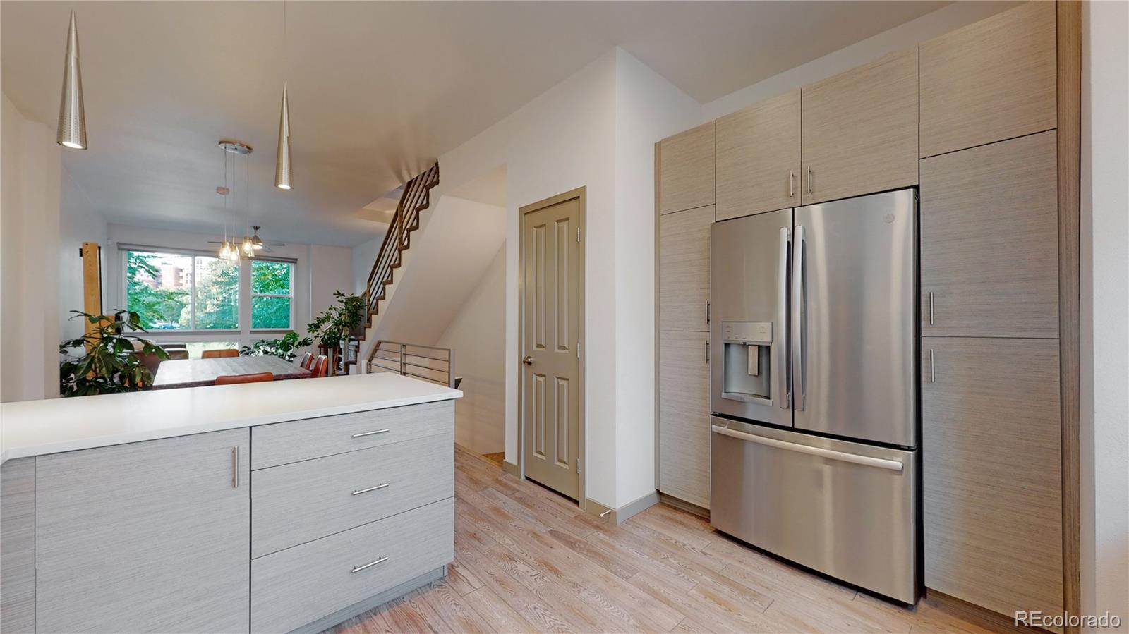 385 22nd Street, Unit 4 Denver, CO 80205 - Photo 14 of 40 a kitchen with white cabinets and stainless steel appliances