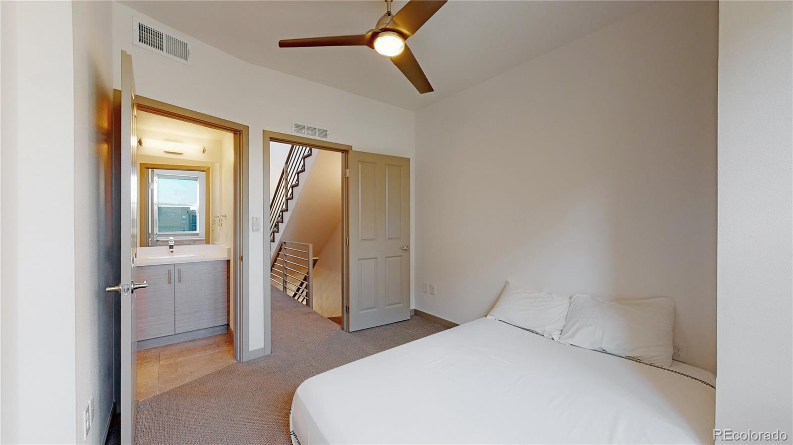 385 22nd Street, Unit 4 Denver, CO 80205 - Photo 17 of 40 a bedroom with a bed and a window