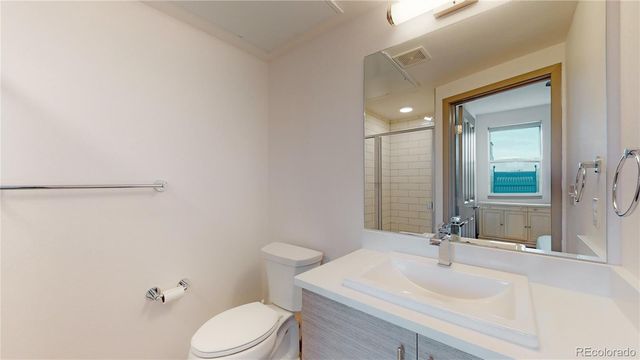 a bathroom with a sink toilet vanity and mirror