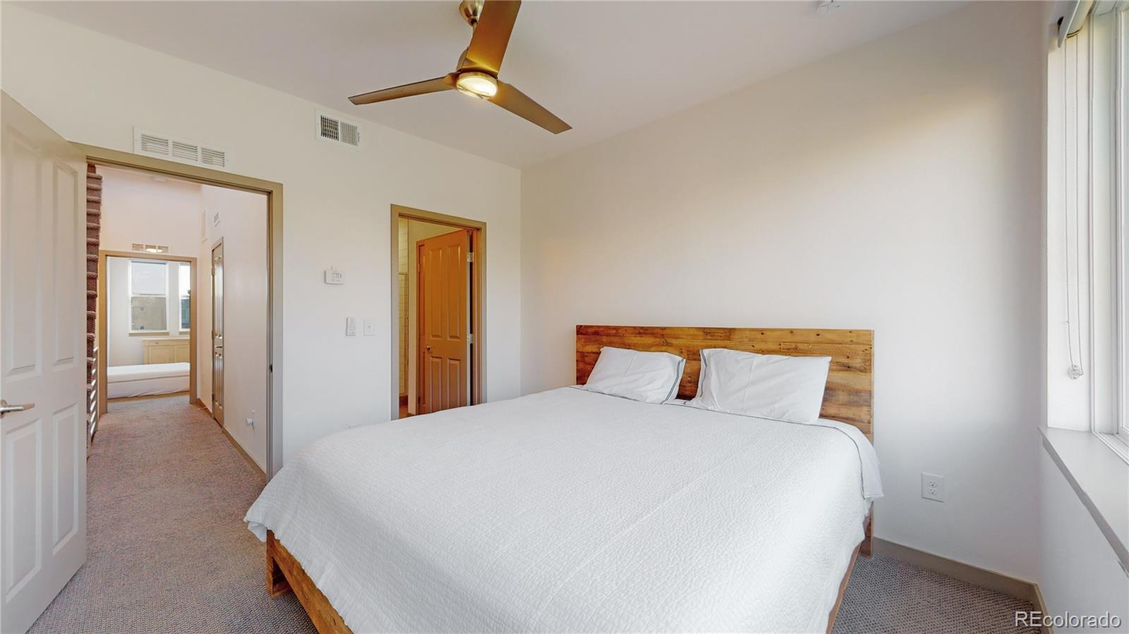 385 22nd Street, Unit 4 Denver, CO 80205 - Photo 20 of 40 a bed room with a bed and a night stand