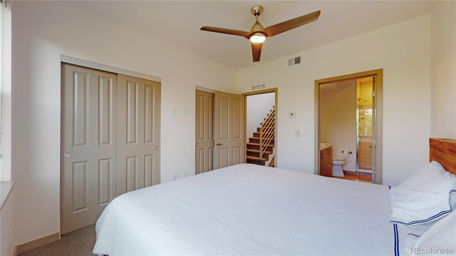 385 22nd Street, Unit 4 Denver, CO 80205 - Photo 21 of 40 a bedroom with a large bed and a chandelier