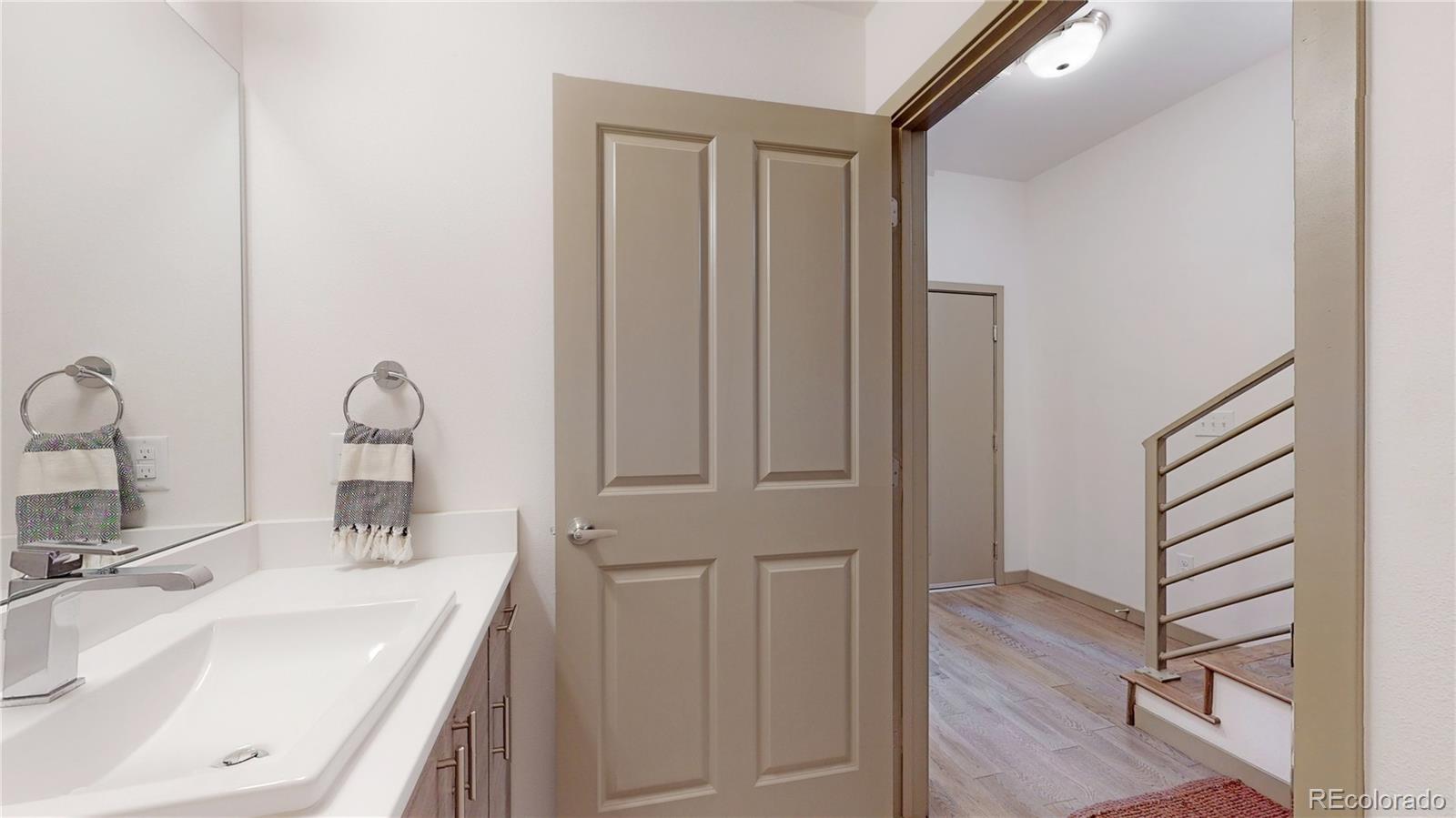 385 22nd Street, Unit 4 Denver, CO 80205 - Photo 23 of 40 a bathroom with a sink and a mirror
