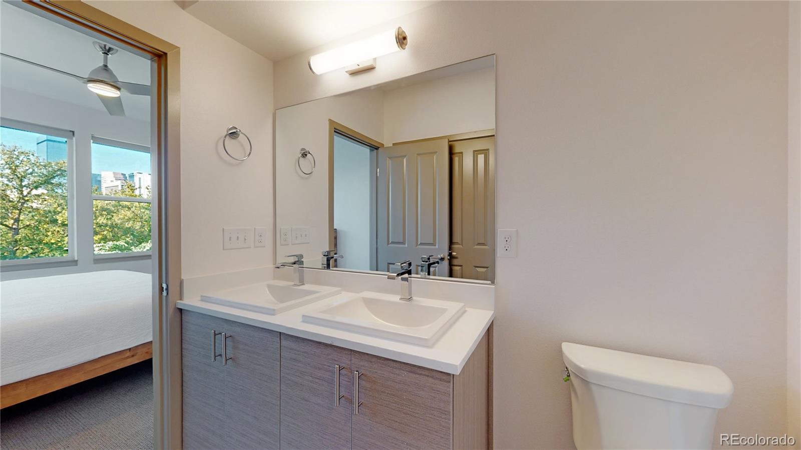 385 22nd Street, Unit 4 Denver, CO 80205 - Photo 25 of 40 a bathroom with a sink and a mirror