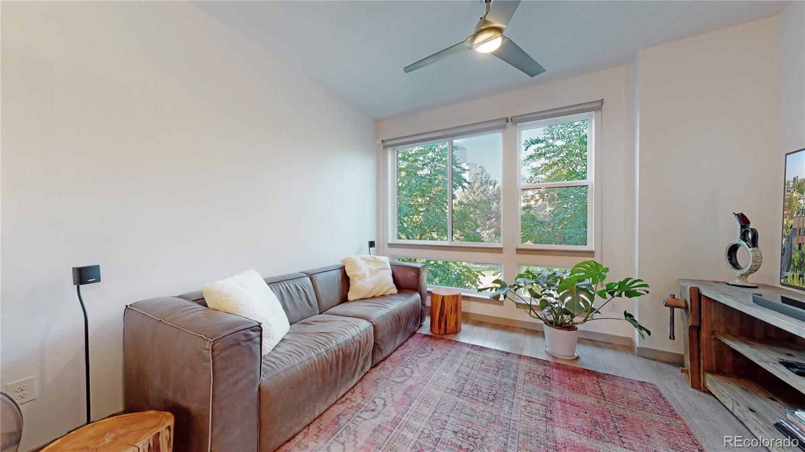385 22nd Street, Unit 4 Denver, CO 80205 - Photo 5 of 40 a living room with furniture and a potted plant