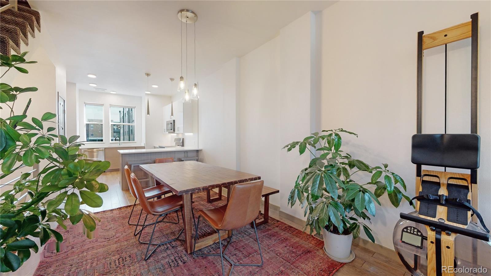 385 22nd Street, Unit 4 Denver, CO 80205 - Photo 8 of 40 a view of a dining room with furniture and a potted plant