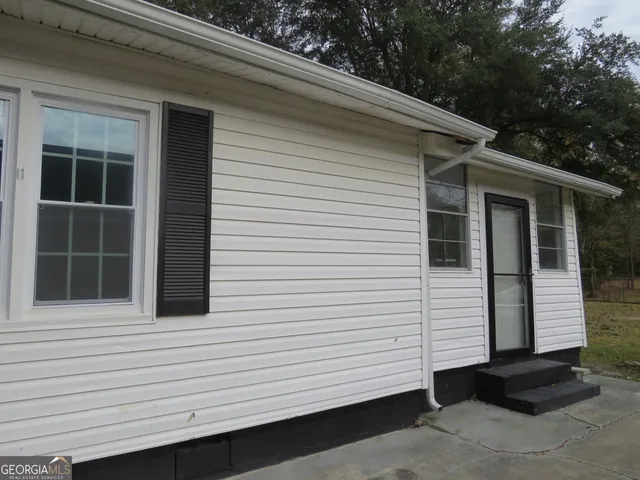 a house with trees in the background