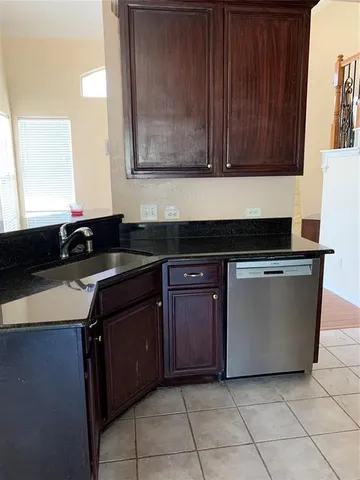 a kitchen with granite countertop a cabinets and a stove