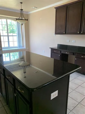 a kitchen with a sink and a refrigerator