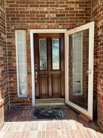 a view of a brick house with large windows
