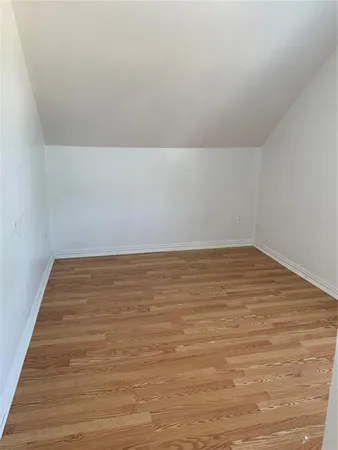 an empty room with a fan and a window