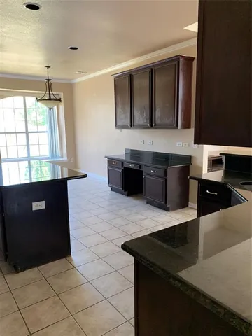 a kitchen with a sink a counter top space and cabinets