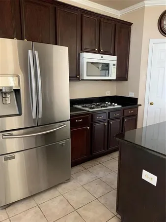 a kitchen with stainless steel appliances a refrigerator stove and microwave