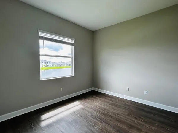 a view of hallway with wooden floor