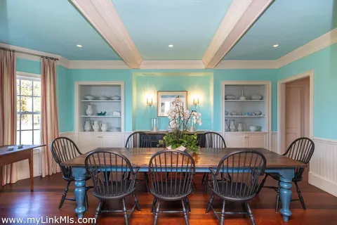 a view of a living room with wooden floor and furniture